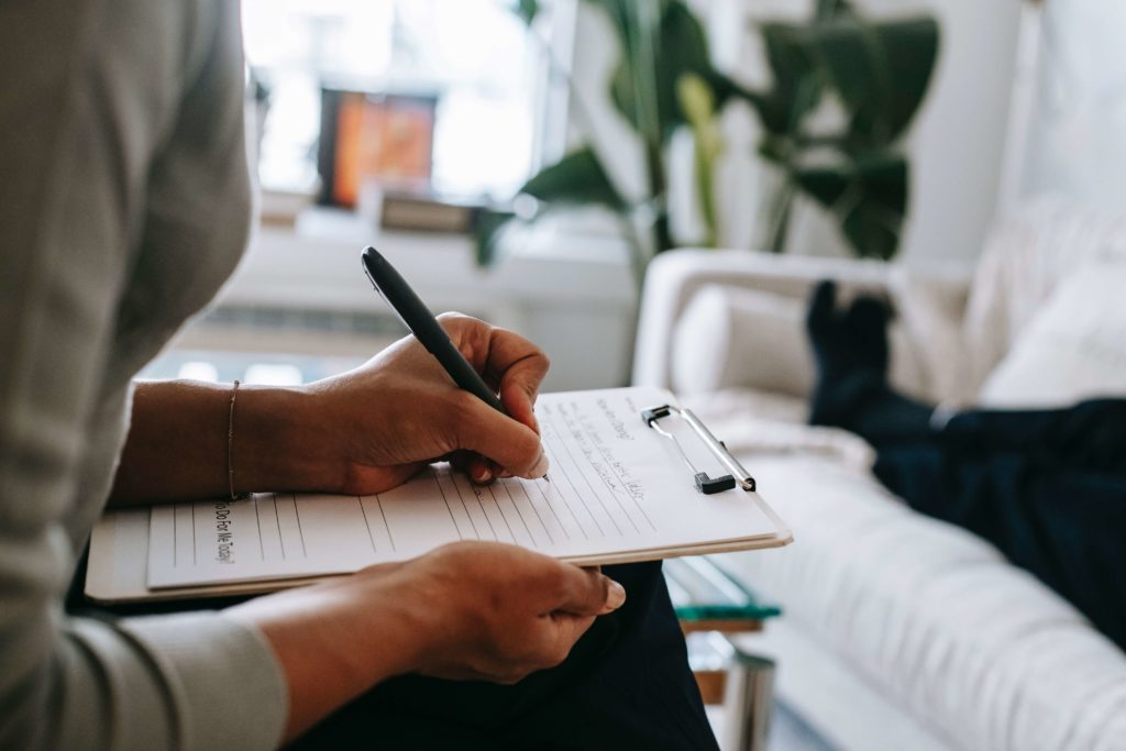 Taking notes during individual therapy. pexels-alex-green-5699456.